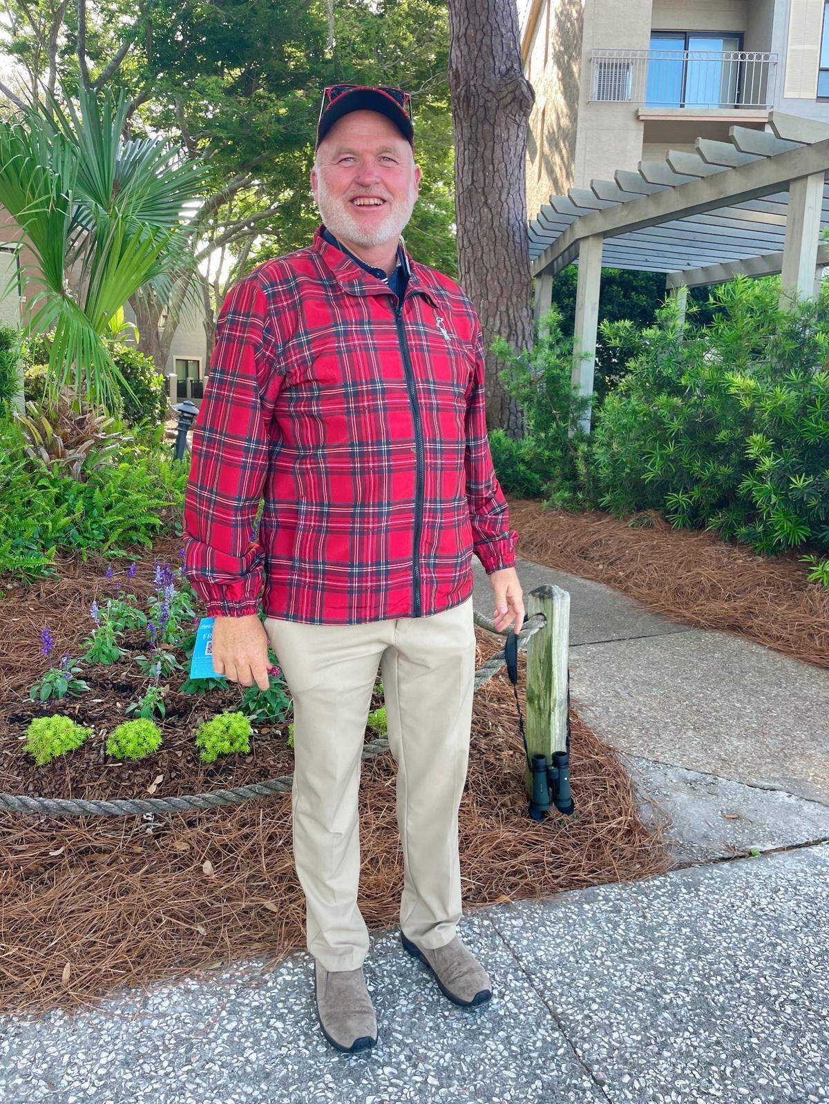 A man poses by the Harbour Town Yacht Basin on his way to the 2022 RBC Heritage tournament.