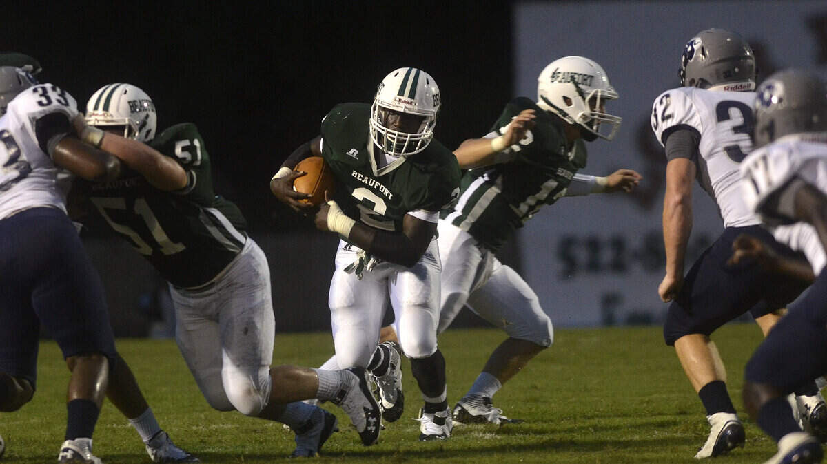 Beaufort's Omar Cummings runs with the ball during their game against Colleton County on Friday night at Beaufort High School on Lady's Island.