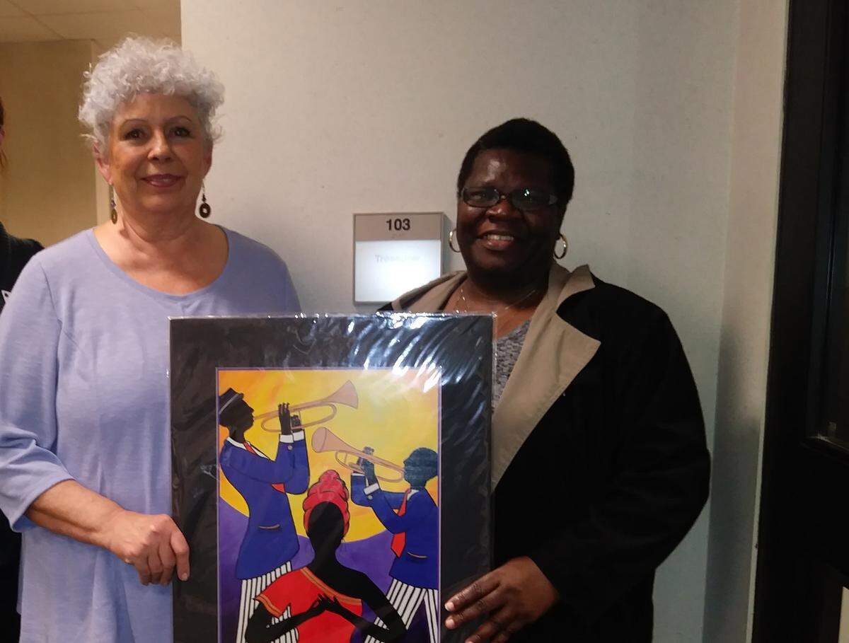 Samantha Claar (center) and Laura Jones on Friday, Dec. 14 with a piece of Claar’s artwork.