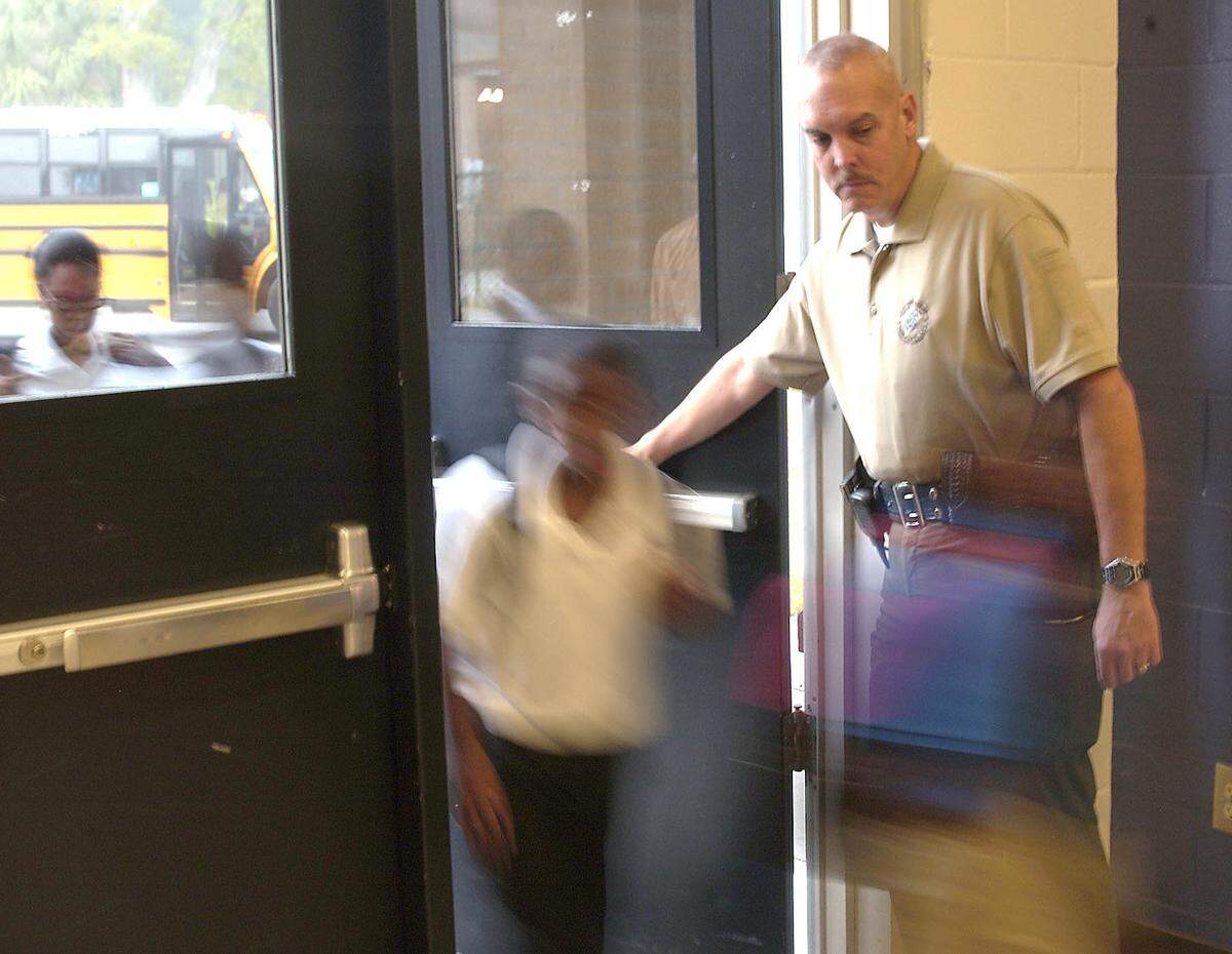 School Resource Officer Eric Melendez of the Beaufort County Sheriffs Office greets arriving fifth and sixth graders Thursday morning at Whale Branch Middle School in 2009.