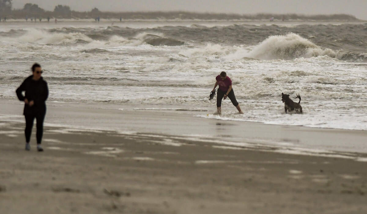 A cold front moving into the Lowcountry with the potential for creating severe thunderstorms whipped up the surf keeping swimmers and surfers out of the ocean yet didn’t stop a woman from playing fetch with the dog on Thursday, March 31, 2022 at Burkes Beach on Hilton Head Island.