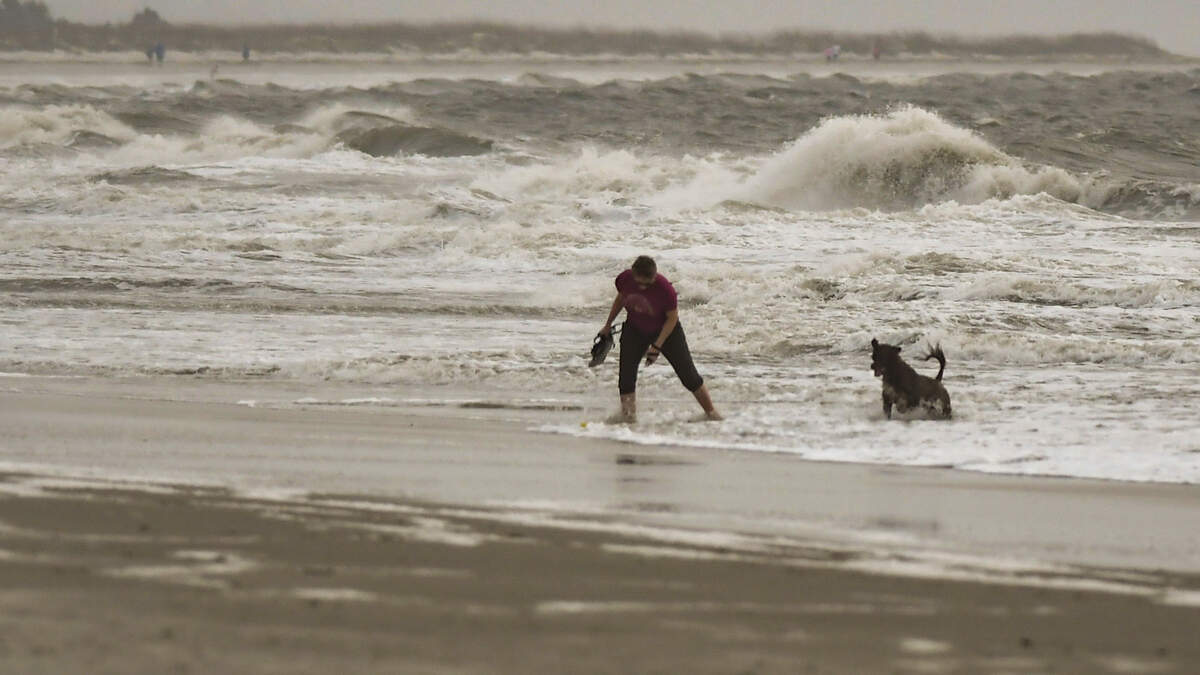 A cold front moving into the Lowcountry with the potential for creating severe thunderstorms whipped up the surf keeping swimmers and surfers out of the ocean yet didn’t stop a woman from playing fetch with the dog on Thursday, March 31, 2022 at Burkes Beach on Hilton Head Island.