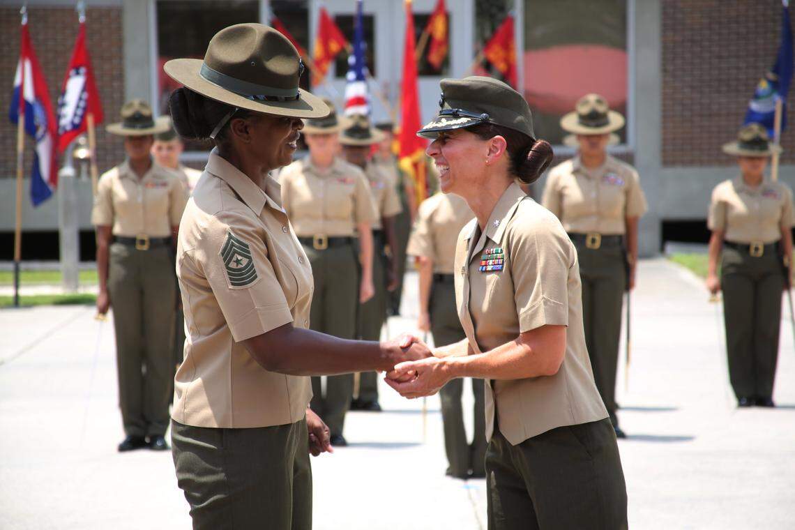 U.S. Marine Lt. Col. Kate I. Germano (ret.), then-commander of 4th Recruit Training Battalion on Marine Corps Recruit Depot Parris Island congratulates a fellow Marine during a July 2014 ceremony at the depot.