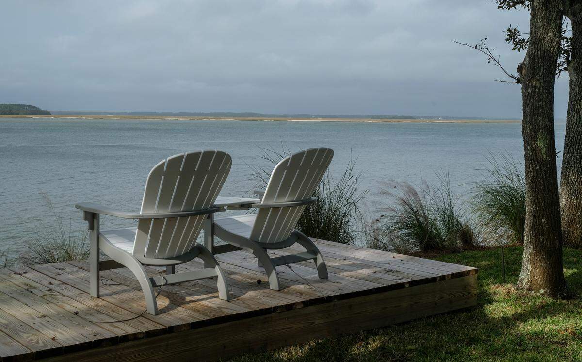 Chairs fastened to a wooden deck offer views of Calibogue Sound as seen on Wednesday, Nov. 11, 2020 in the non-gated community of Spanish Wells on Hilton Head Island. With decks and stairways to the sound are on one side of Brams Point Road peninsula, the owners mansions are on the other side built along Broad Creek.