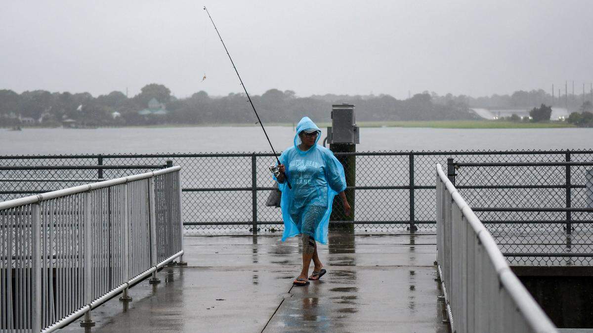 Visiting from Virginia, a woman leaves the C.C. Haig Point Landing during Tropical Storm Debby on August. 5, 2024 on Pinckney Island.