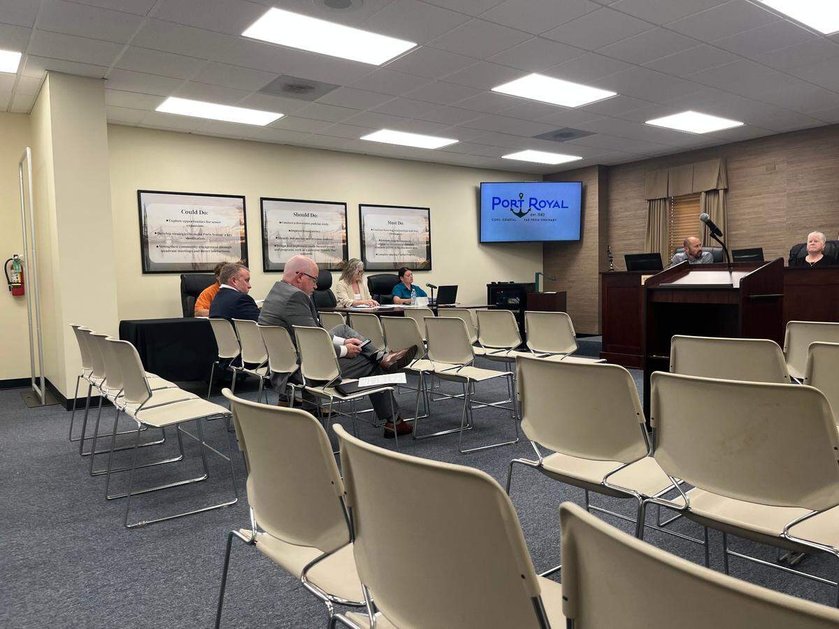 John O’Toole, executive director of the Beaufort County Economic Development Corp., right, waits to speak at a Port Royal Town Council meeting Wednesday. Seated to his left is Brian Warner, a BCEDC economic development specialist.