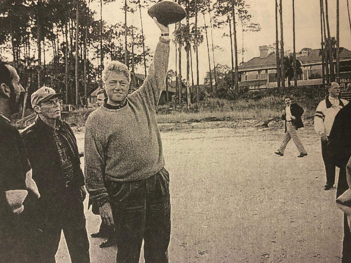 President Bill Clinton holds a football aloft on the beach in Palmetto Dunes during his New Year’s weekend visit to Hilton Head in 1995.