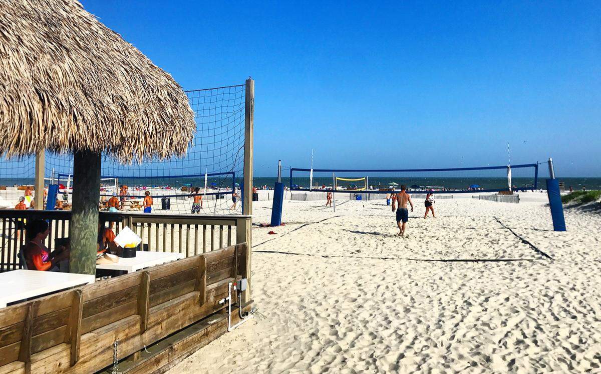 The thatched roof Tiki Hut overlooks the volleyball courts on Hilton Head’s busy Coligny Beach.