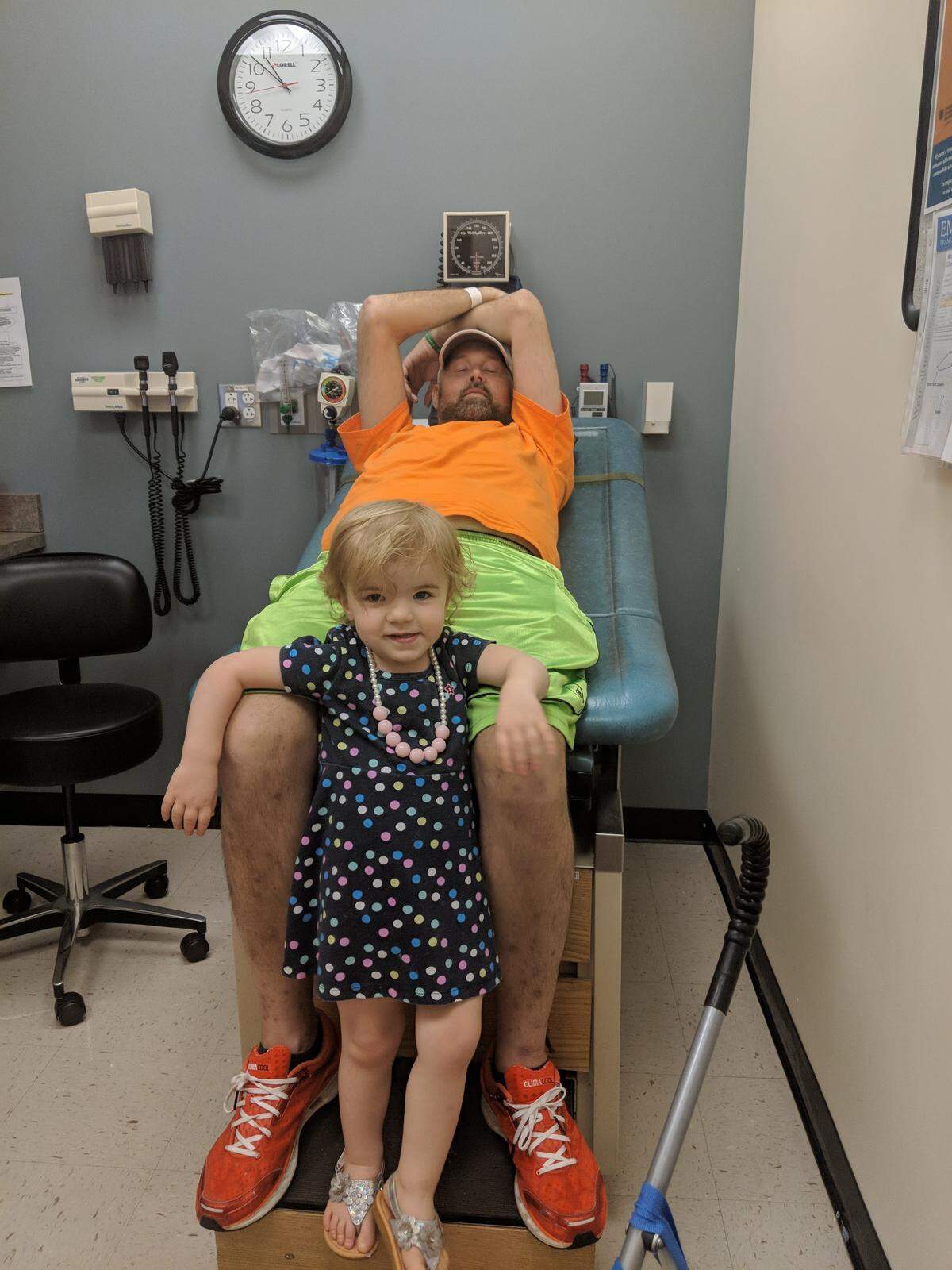 Norah Albany rests on father Dave’s knees.