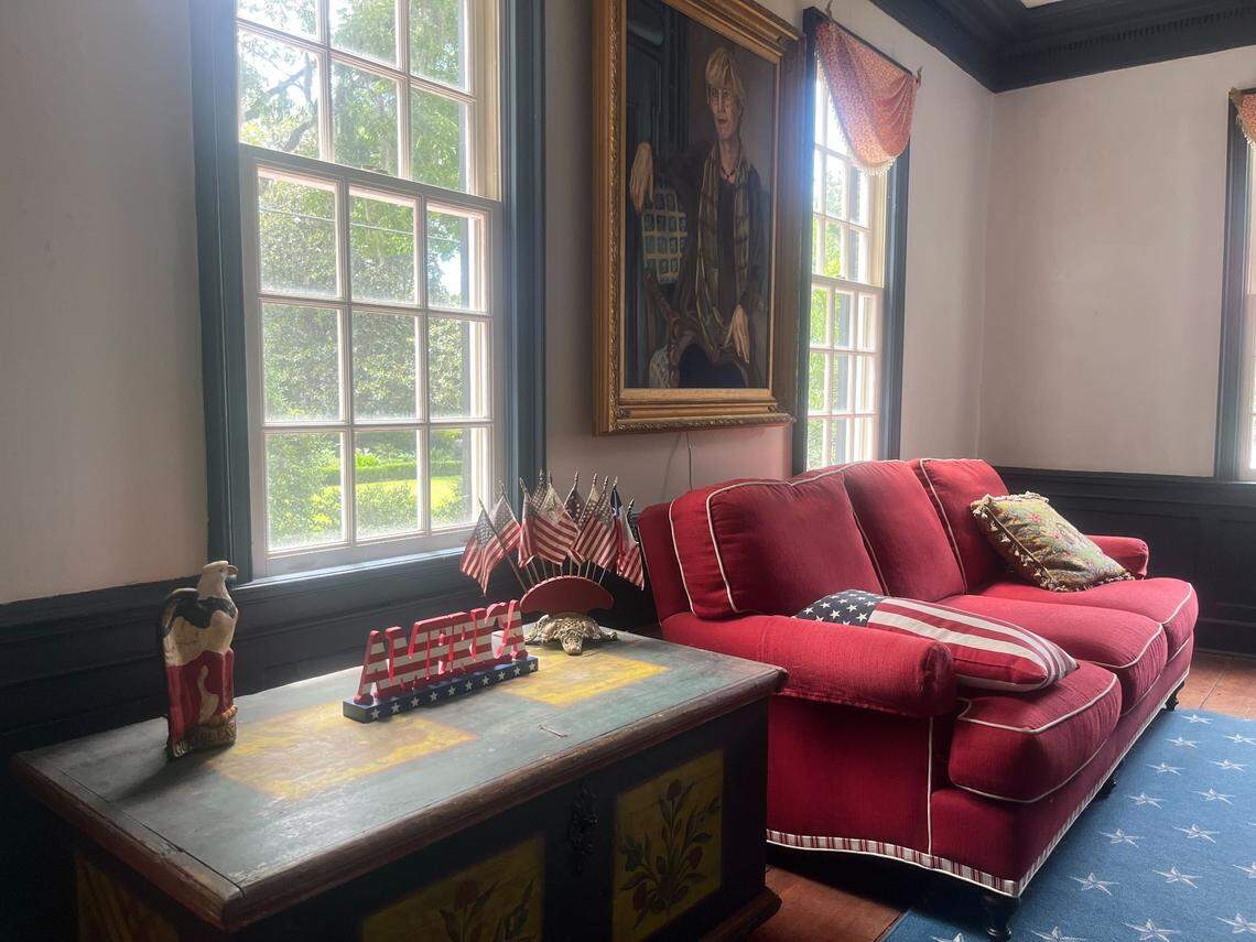 Decorations at the William Johnson House in Beaufort, built circa 1776, has a patriotic theme thanks to Pam Taub, depicted in the painting. Pam and husband David are the owners. The property is for sale.