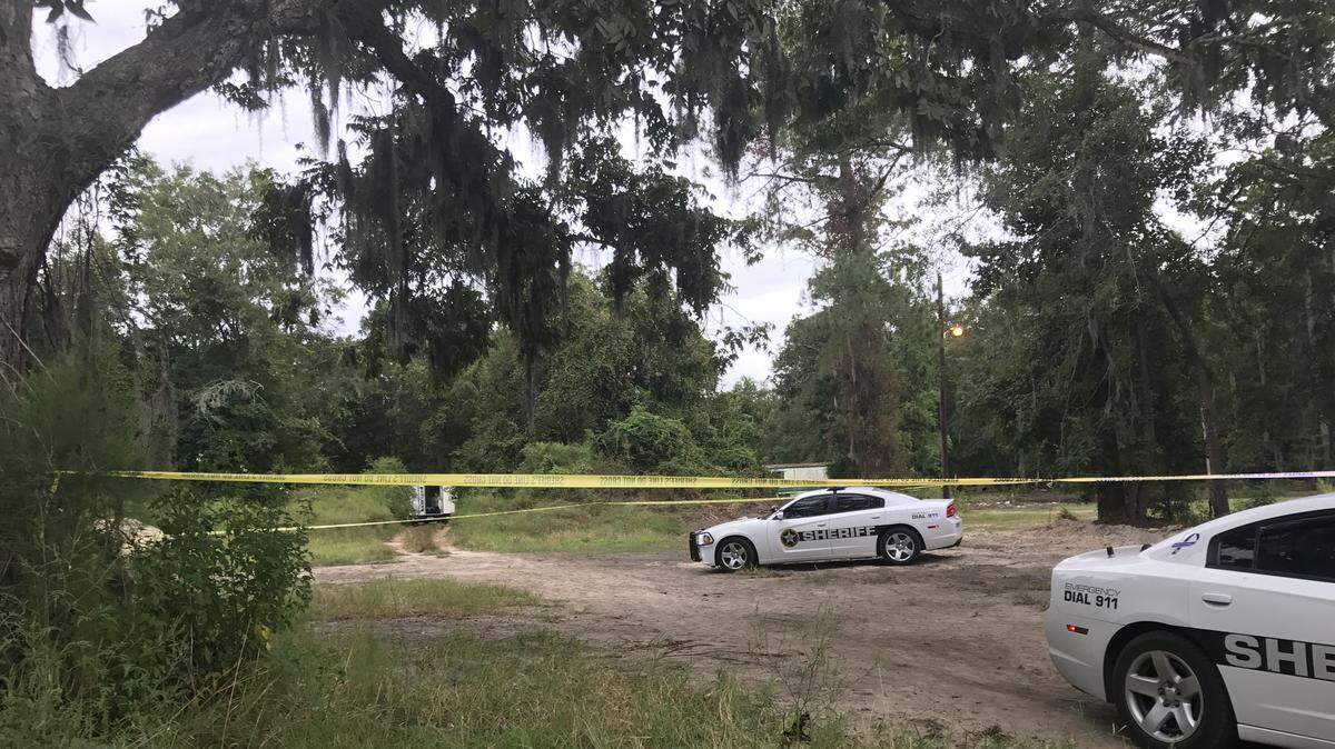 Crime scene tape stretched across a wooded lot off Castle Rock Road in Burton Sunday night.