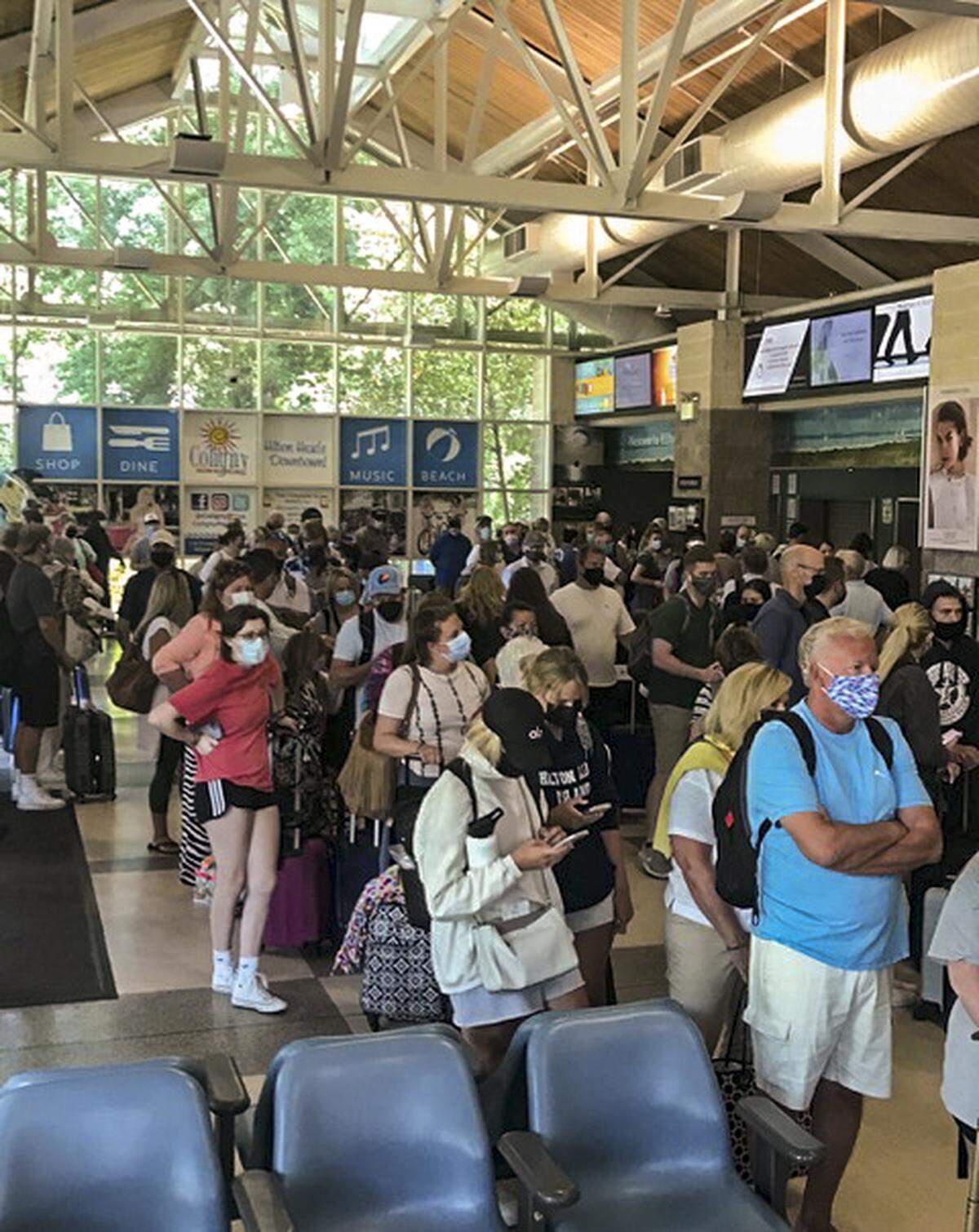Crowds wait in line for the security checkpoint at the Hilton Head Island Airport on May 22. The airport has seen an influx of travelers in recent weeks due to a record number of new flights on the weekends and pent-up demand.