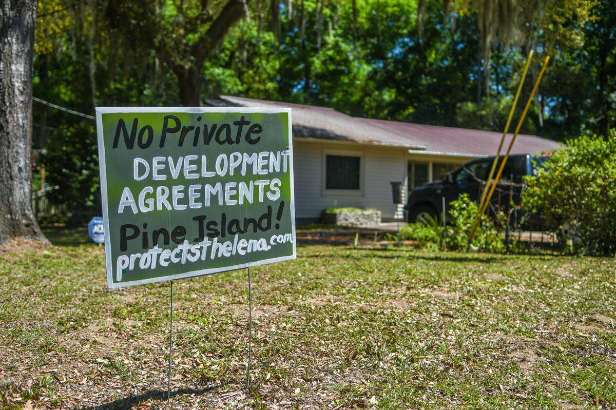 Yard signs, seen here in 2023, denounced the proposed development of Pine Island into a gated, golf course community on St. Helena Island.