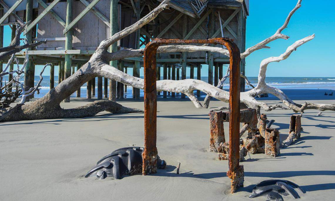 If not for the tractor’s tires, a piece of rusted steel would likely not be identifiable as the equipment’s roll over protective cage being covered by Pritchards Island as seen on Friday, April 8, 2022. The equipment is buried to the south of the abandoned Pritchards Island laboratory.
