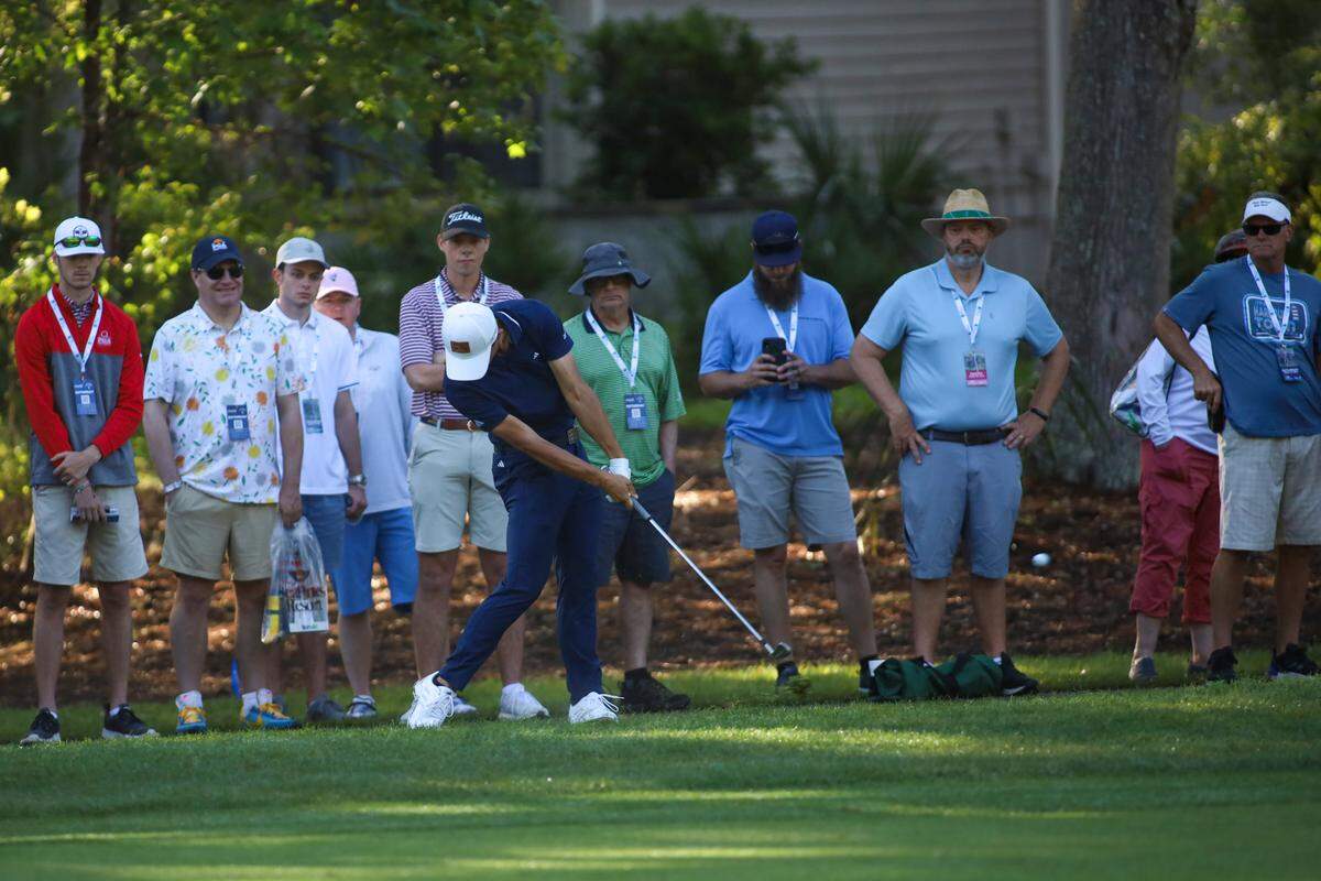Spectators watch as Collin Morikawa hits out of the rough on the third hole during the third round of the RBC Heritage Presented by Boeing at Harbour Town Golf Links on Saturday, April 15, 2023, in Sea Pines on Hilton Head Island.