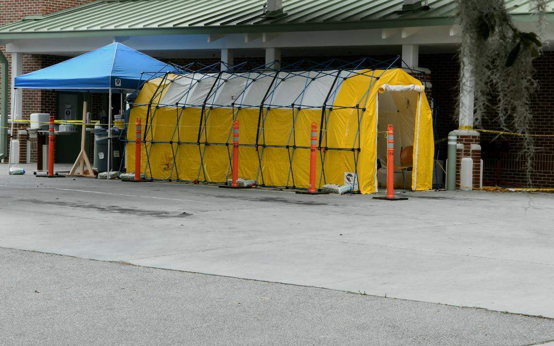 A triage tent outside the emergency entrance of Beaufort Memorial Hospital as seen on Monday, March 23, 2020. The tent, likely set up in response to the COVID-19 virus, was outfitted with at least one individual in a full-body, protective gown wearing a plastic eye shield and face mask, who was waiting for patients inside.
