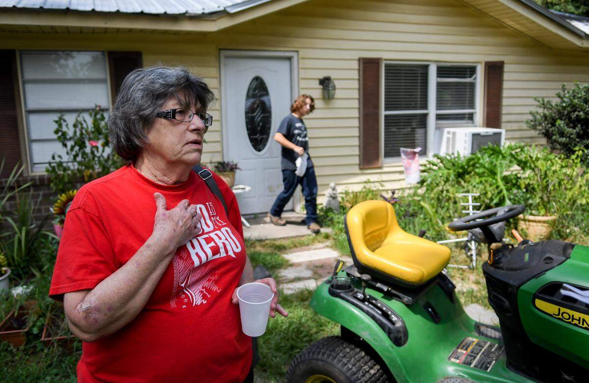 Mary Benton says she’s unsure what to do when asked on Thursday whether her family was going to leave their home on Schinger Avenue in Ridgleland due to the toxic smoke emitted by Able Contracting’s Material Recovery Center as Japheth Douberley, 16, brings an air quality report to his grandmother. On Wednesday evening, Benson was given the air quality readings from an official with the S.C. Department of Health and Environmental Control with dangerously high readings. Benson’s home is less than 600 feet from the recycling center.
