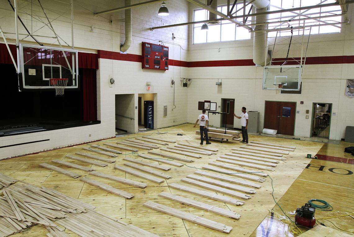 Workers for The Flooring Connection, of Conway, replace the flooring at the Beaufort Middle School gym Sept. 24, 2014, after rain flooded a courtyard, letting water flow onto the gym’s floors.