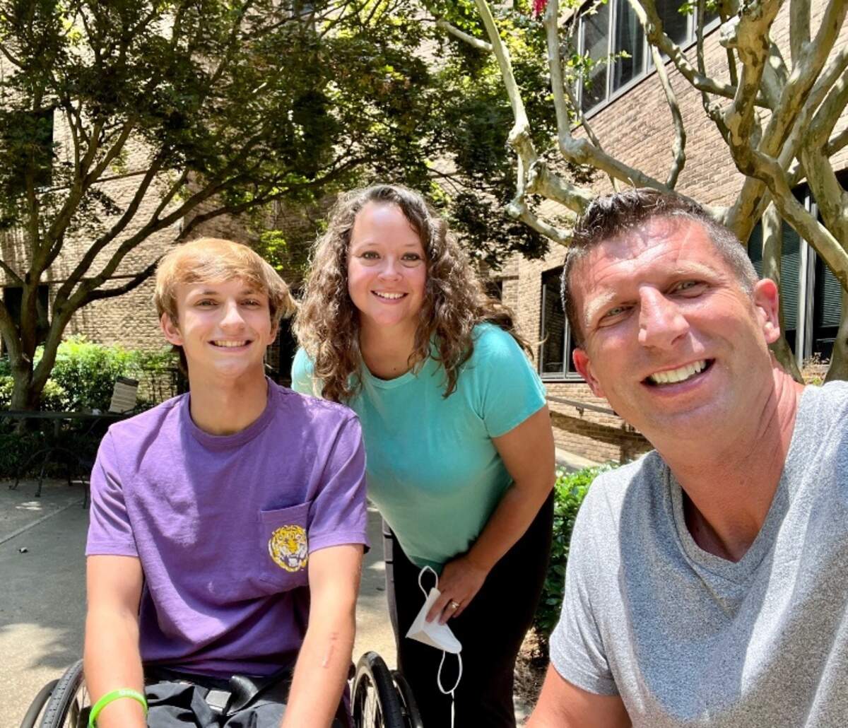 Anderson Jones, a Beaufort teen who suffered a spinal cord injury after a bad fall from a Fripp Island roof, smiles with his parents, Lesley and Jeremy Jones before their trip to Los Angeles with Dream on 3, an organization geared towards helping young people achieve their athletic dreams.