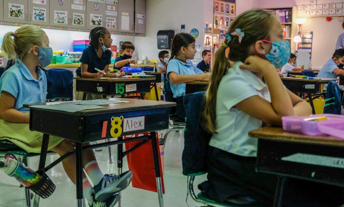 Second-grade students follow along with their teacher as they sing in their Spanish immersion class on Monday, Aug. 16, 2021 on the first day of school at Hilton Head Island Elementary School.