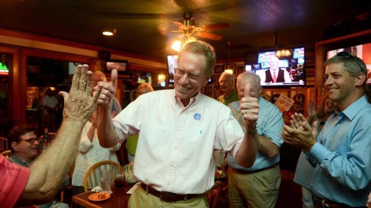 David Ames celebrates with two thumbs up after receiving a call from Brendan Reilley, his closest competition in the polls, congratulating him on winning the Ward 3 spot on the Hilton Head Town Council on Tuesday, May 3, 2016, at Casey’s Sports Bar & Grille on Hilton Head Island.