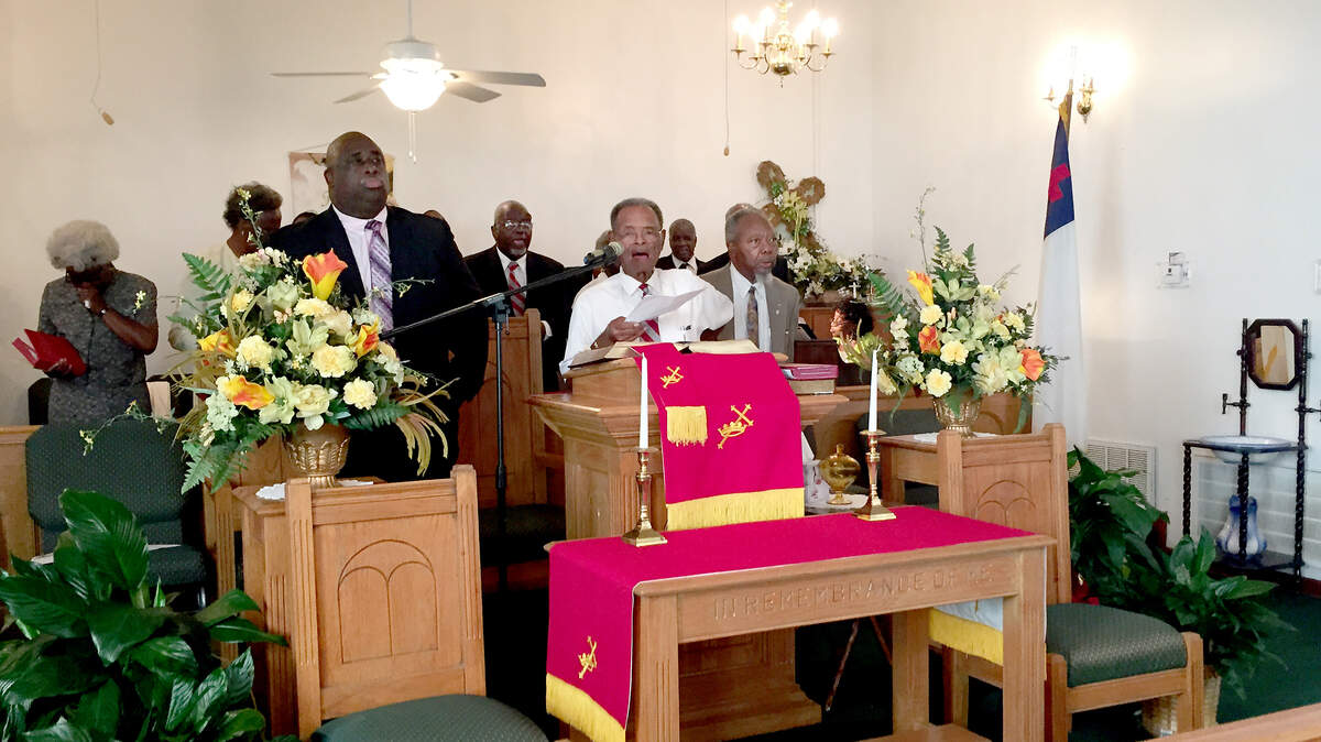 At the pulpit, from left, church pastor the Rev. Gregory M. Kinsey, worship leader Alphonso Tyler and the retired Rev. Thomas E. McClary at St. John A.M.E. Church near Ridgeland, where the late Clementa Pinckney first preached at age 13 and who later served as senior pastor at the church from 2009 to 2010. This photo was taken in June 2015.