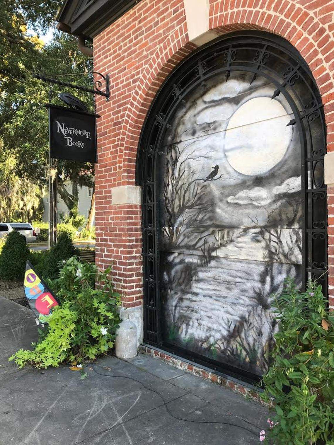 David Anderson, who owns Nevermore Books with his wife Lorrie, painted a mural on a piece of plywood holding the place of a window in their store.