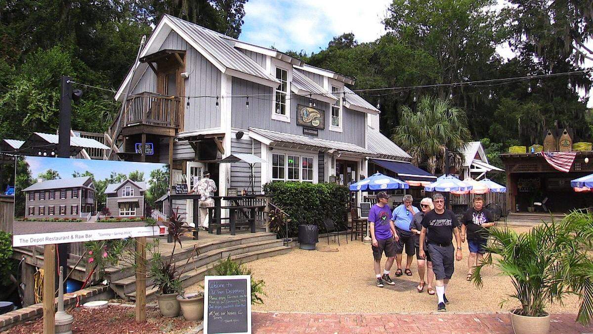 In this September 2016 file photo, patrons of Old Town Dispensary in Old Town Bluffton walk past a sign for owner Thomas Viljac’s next creation - The Depot, next door to the Dispensary. The restaurant was slated to open in November of that year but still has not.