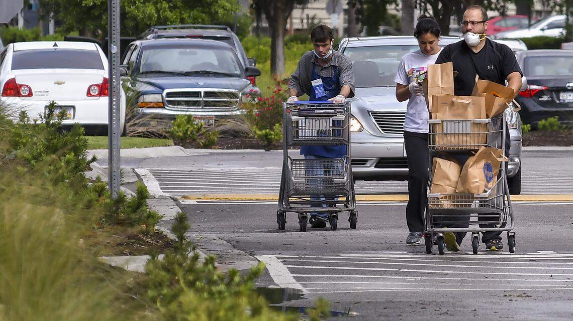 Shoppers leaves the Kroger at Belfair Commons in Bluffton on Thursday, April 30, one with a mask and another in gloves.