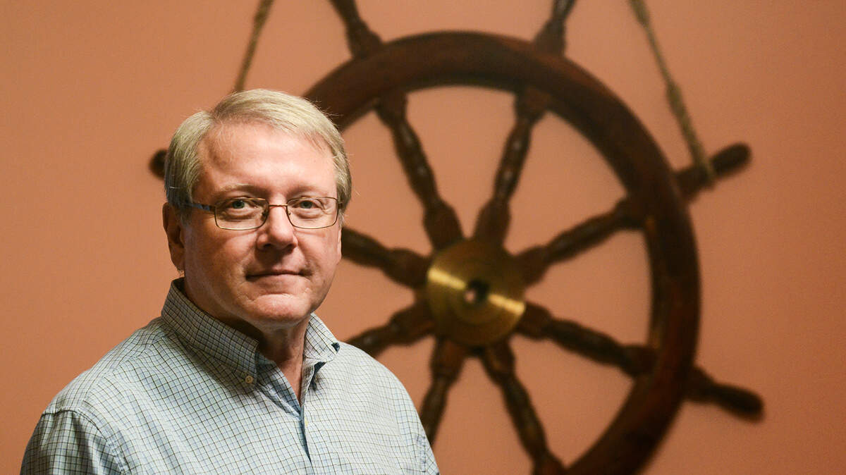 Beaufort's Jerry Cartmill on Jan. 21 with the ship's wheel of one of the vessels on which he served in the Coast Guard. He is now retired from the service.
