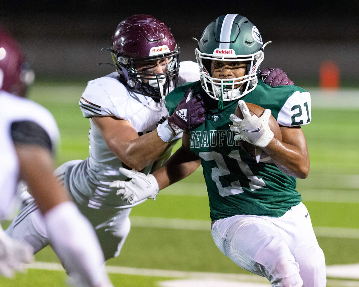 Beaufort senior running back Amariee Morris (21) breaks a tackle as the Eagles defeated the Benedictine Cadets 33-23 in Beaufort, SC, Friday, Sept, 3, 2021. The Eagles improve to 3-0 on the season and will next face West Ashley at home, Friday, Sept. 10. (Tony Kukulich FOR THE ISLAND PACKET)