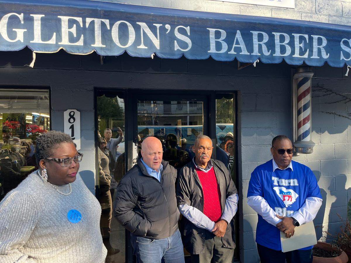 Christale Spain, chairwoman of the South Carolina Democratic Party, and Mitch Landrieu , co-chairman of the Biden-Harris campaign, join Kenneth Singleton Sr. and Charles Henderson, at a rally before Saturday’s Democratic primary.