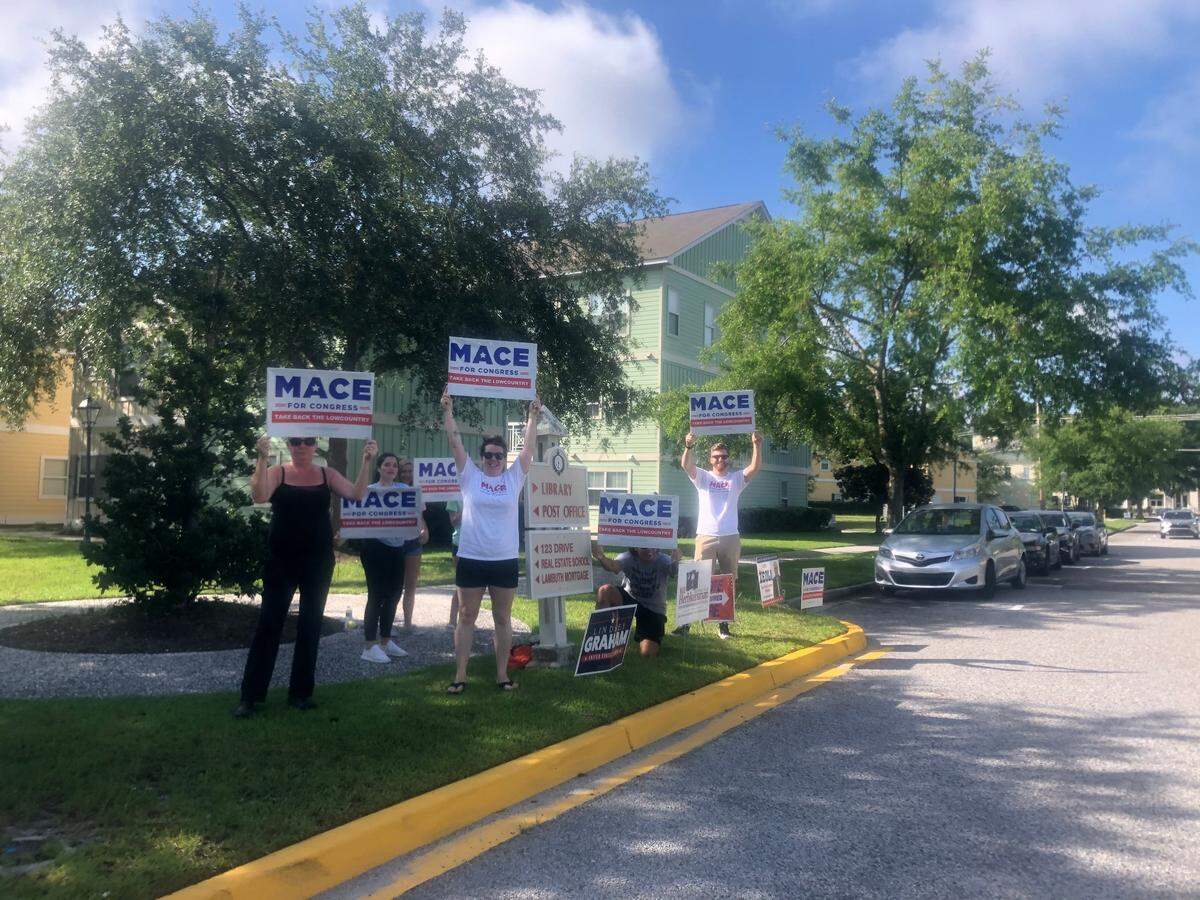 A small group of campaigners stand about 500 feet from the entrance to the Bluffton Library on Tuesday, June 9, 2020 to show their support for Nancy Mace.