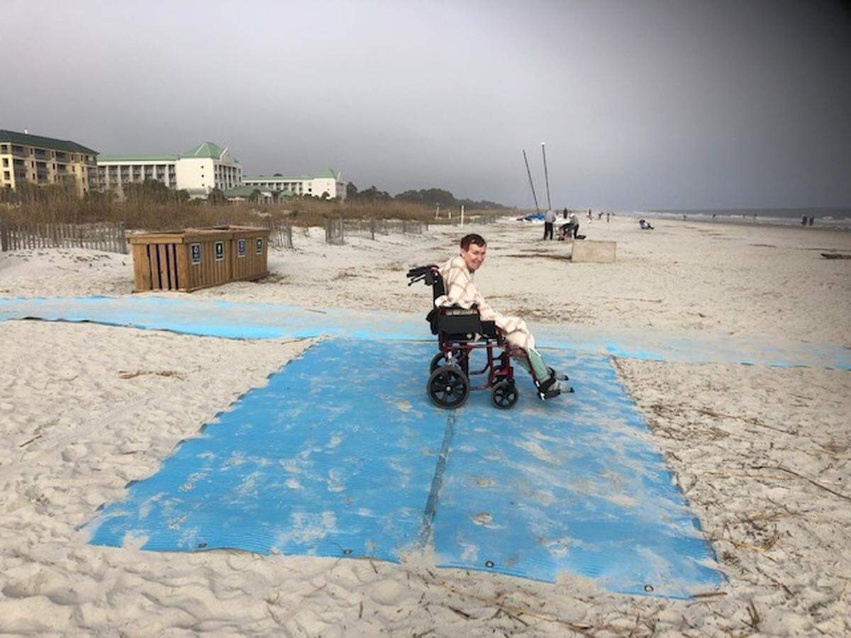 Kathy Carlozzi at the beach in January on Hilton Head Island. Her husband, Ken, said the sand whipped her face on the uncovered blue mats.