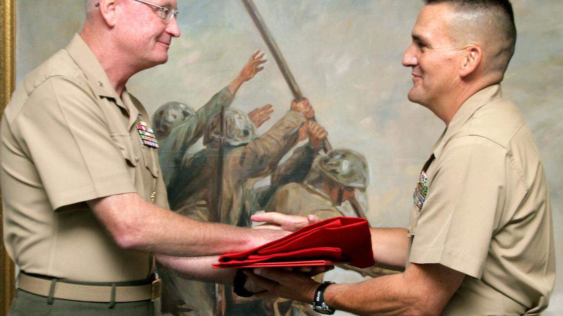 Brig. Gen. James B. Laster, left, the former commanding general of Marine Corps Recruit Depot Parris Island, presents Brig. Gen. Frederick M. Padilla, the new commanding general, with the distinguished general officers' flag at Barrow Hall on Friday. .