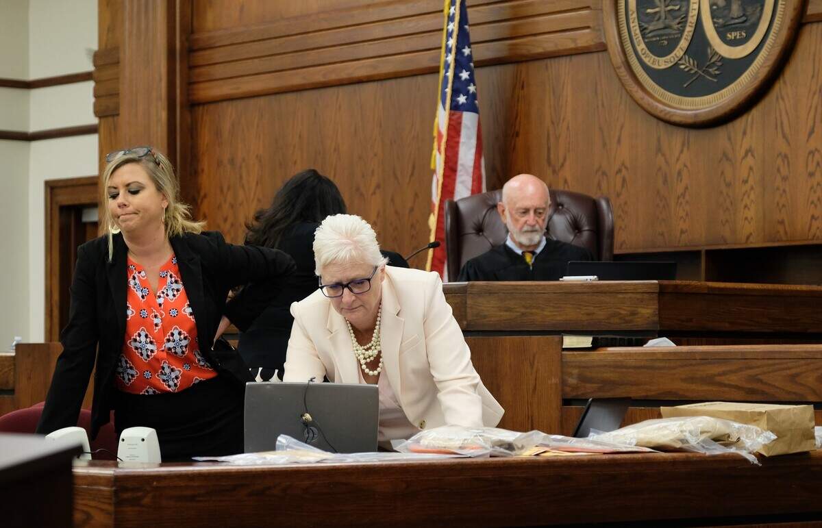 In a 2018 photo, Defense attorney Trasi Campbell, right, looks over the court reporter’s transcript as prosecuting attorney Hunter Swanson, stands by. Campbell wanted “to impeach” the state’s rape victim for what Campbell considered to be an inconsistent statement at Isaiah Gadson Jr.’s trial at the Beaufort County Courthouse. Judge Brooks Goldsmith, in the back, later allowed Campbell to read the witness’ statement back to her on the stand. Gadson was linked by DNA to the January 1980 cold case murder of 18-year-old David Krulewicz and the rape of Krulewicz’s 15-year-old girlfriend in Burton.