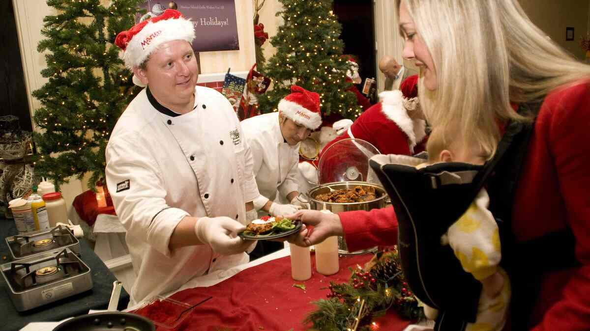 FILE: Patrons enjoy the 2013 Taste of the Season. Here, Brad Blake, executive chef at the Skull Creek Boathouse, serves up some fare.