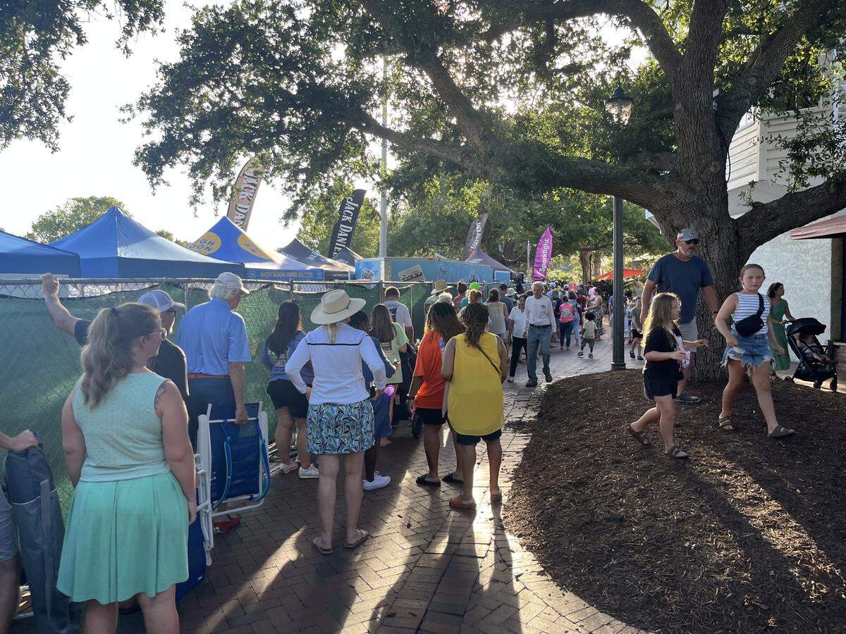 The Lowcountry Supper during the Water Festival attracts a large crowd in July. A social district the city is creating that will allow visitors to carry cups of beer and wine. This walking path behind businesses that front Bay Street will be part of the district.