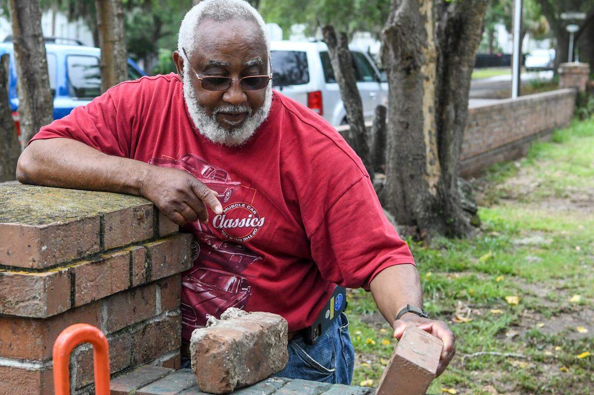 Beaufort resident and former county coroner Ed Allen, whose great-great-grandfather was a soldier in the U.S. Colored Troops in the Civil War, talks of the differences on June 29, 2022 between a historical brick, left, and a brick of today. Structural repairs to the Grand Army of the Republic Hall included re-using the original handmade, solid bricks to rebuild the footings of the building located on Newcastle Street in downtown Beaufort.
