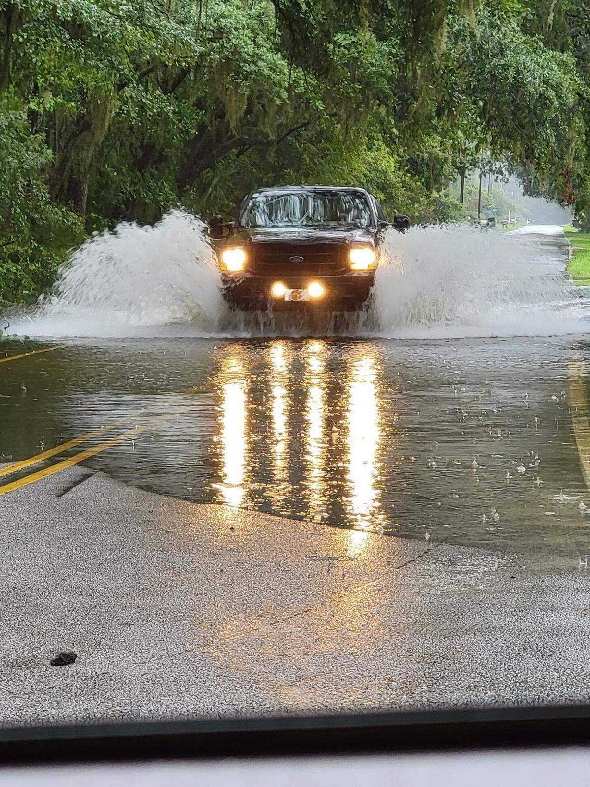 A truck driving through flood waters in the Alljoy neighborhood in Bluffton, South Carolina, on Monday, Aug. 5, 2024.