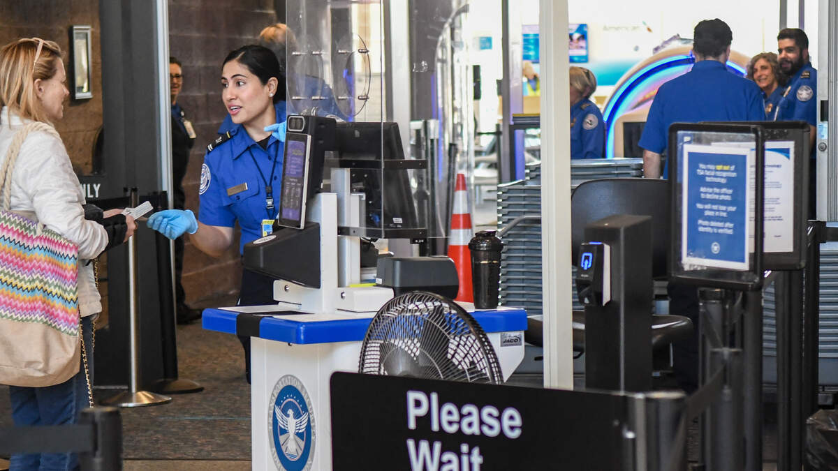 A Transportation Security Officer returns a customer’s identification on the afternoon of Nov. 17, 2025, on a direct flight to Charlotte, N.C., on American Airlines at Hilton Head Island Airport.