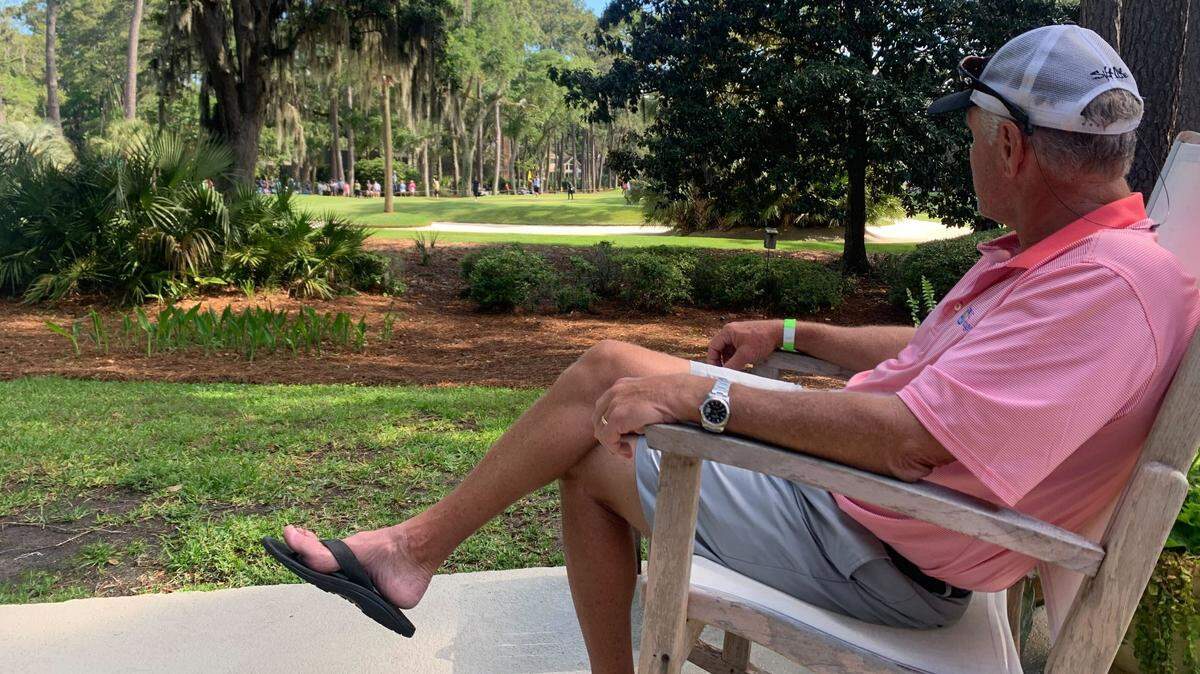 Renting a house in Sea Pines, Lyle Van Wyk watches golfers putt on hole 7 of the RBC Heritage from the comfort of his patio.