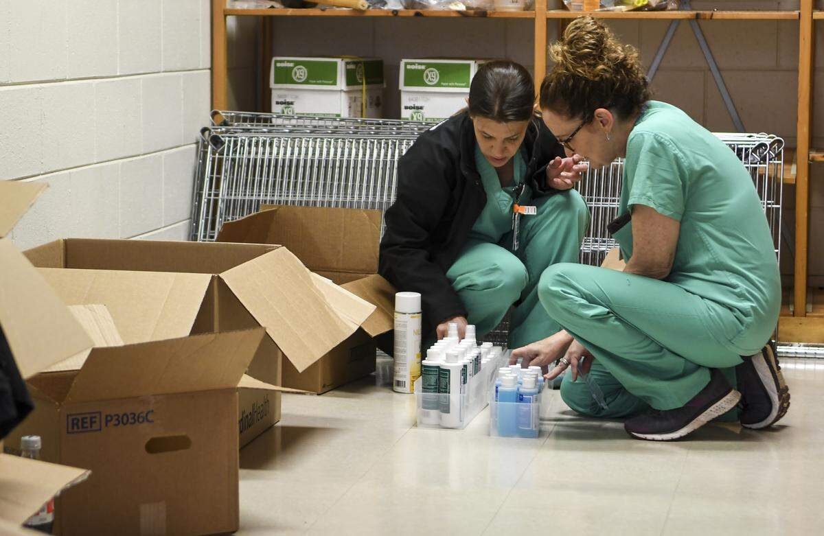 Beaufort Memorial Hospital employees Stephanie Wilson, left, and Sharon Shupe work at categorizing supplies in a room in the gymnasium of Beaufort Middle School on Wednesday, April 22, 2020. The hospital built the field hospital in the gym as it anticipated a surge in COVID-19 patients.