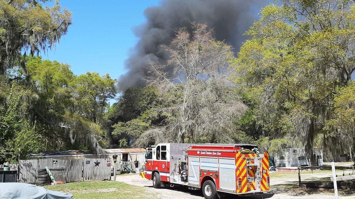 Firefighters respond to a call on Easter Sunday, April 4, 2021, as black smoke billows from a large debris pile at a residence on Broad River Boulevard in Beaufort.