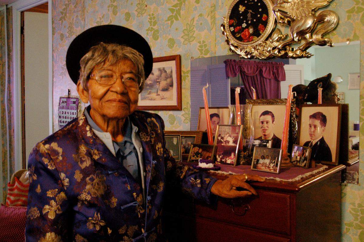 Lyda C. Youmans poses in her home in 2012 with photos of members of the Berol family she worked for for 40 years at Davant Plantation, today the site of the Congaree Golf Club.