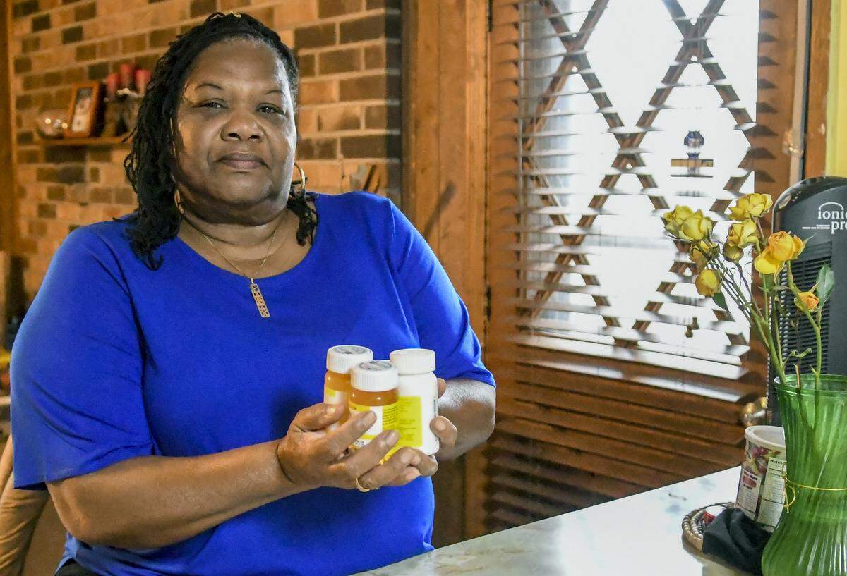 Claretha Singleton holds the life-saving medication she must take at her home on Thursday (11/14) on St. Helena Island. Singleton had to get a personal bank loan to reimburse Beaufort Naval Hospital more than $10,000 after the hospital made the mistake of fulfilling her prescriptions for 12 years until, according to Singleton, a new computer system flagged her when she tried to refill her prescriptions.