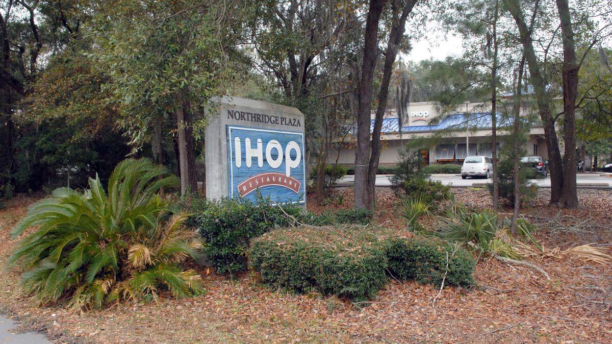 Hilton Head Island’s IHOP restaurant, photographed on Thursday, is partially obscured by vegetation in this view taken from the bike path along William Hilton Parkway.