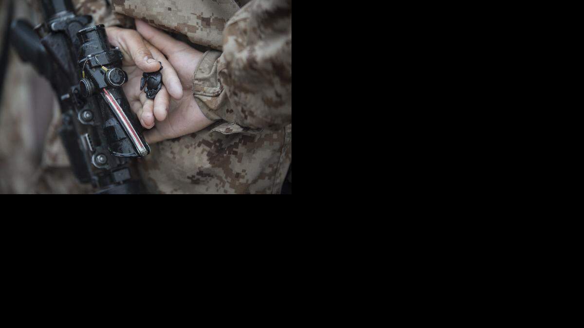 A Marine holds the Eagle, Globe and Anchor emblem after emerging from The Crucible at Marine Corps Recruit Depot Parris Island. 