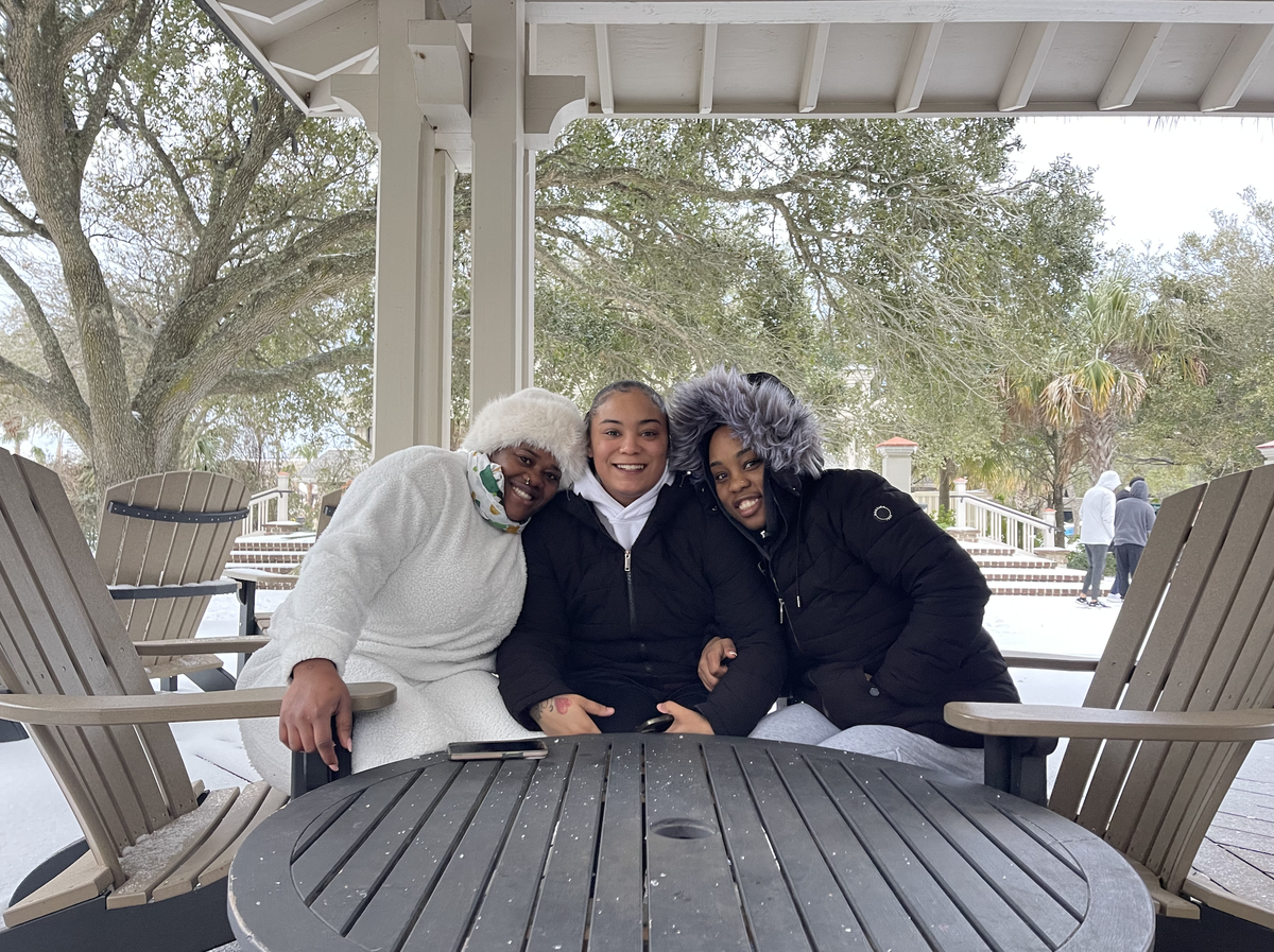 Rose (far left), Ty (middle) and Amanda (far right) ventured out into the snow early Wednesday morning. They kept cover under an overhang at Coligny Beach Park.