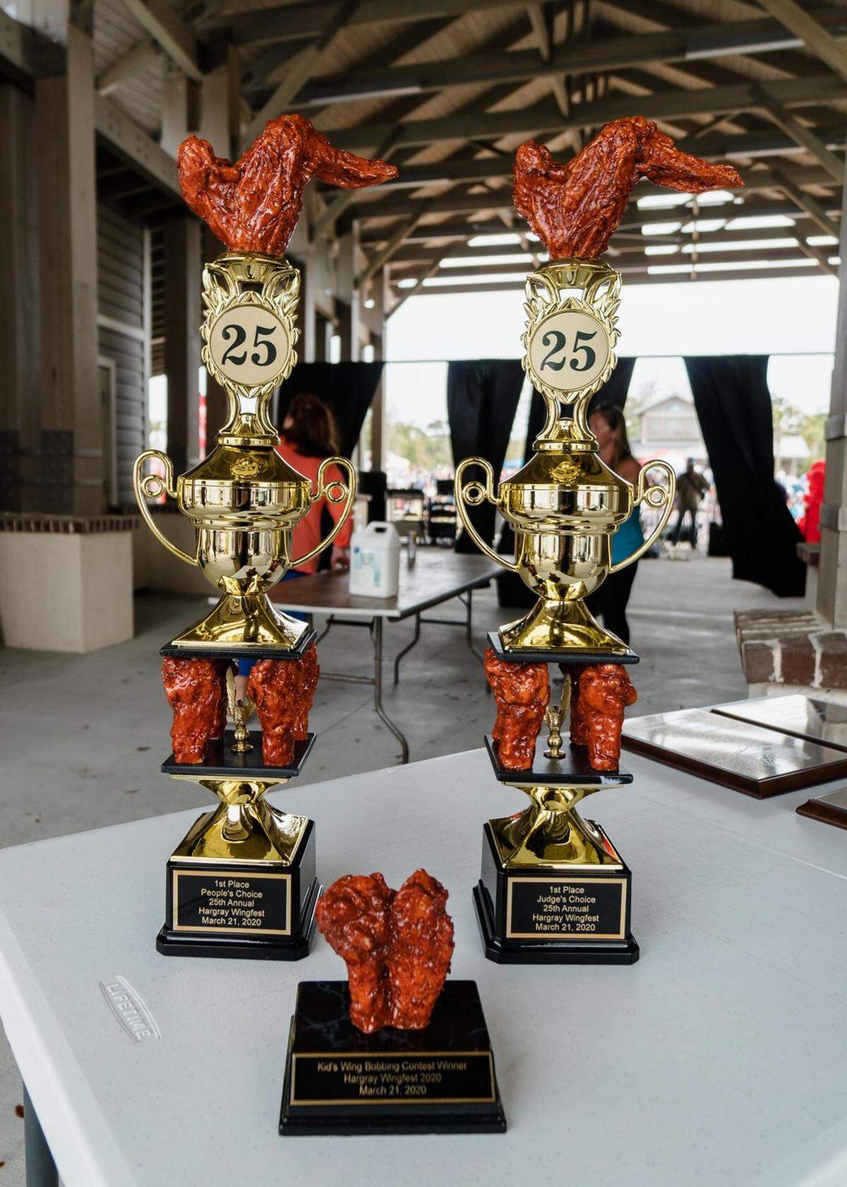 The People’s Choice, Judge’s Choice and Kid’s Bobbing Contest first place winner’s trophies from the 25th annual Wingfest event.